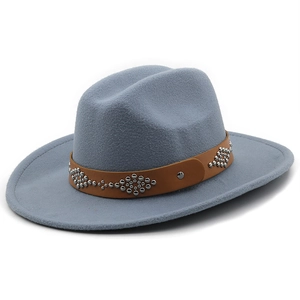 Detail of grey-blue wool fedora with a studded brown leather band and metal buckle