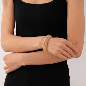 Close-up of translucent amber acrylic cuff with chunky spiral twisted texture on wrist