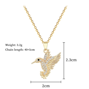 Detail view of gold hummingbird necklace with dimensions 2x2.3cm and 40+5cm chain length