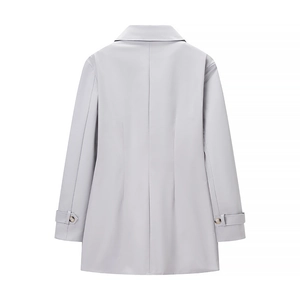Back view of a light gray long trench coat with waist seams and buttoned cuffs