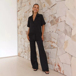 Detail of black short sleeve lapel shirt with pocket and high waist wide leg pants