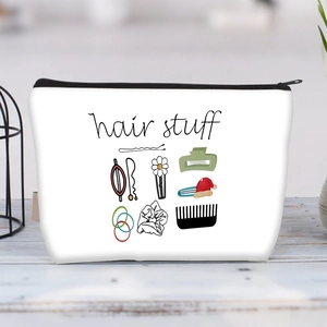 Detail of canvas hair stuff organizer with black zipper and hand-drawn hair accessory icons