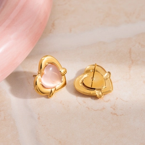 Pink cat-eye heart earrings in gold stainless steel shown from front and back view