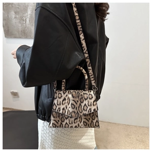 Detail showing elegant leopard print pattern and metal buckle closure on the mini square bag