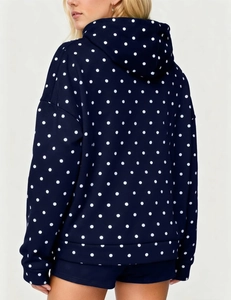 Back view of a navy blue polka dot hoodie with ribbed hem and loose fit for women