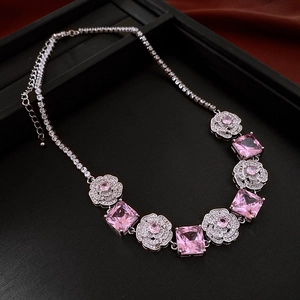 Detail of pink square crystal necklace with rhinestone-encrusted floral links