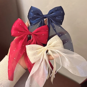 Detailansicht von Organza-Haarspangen mit Perlen und Strass in Marineblau, Rot und Creme