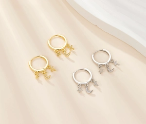 Detailed view of S925 silver star moon cross earrings in gold and silver finishes