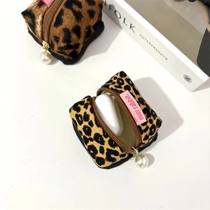 Detail of leopard print corduroy earphone pouch with an elegant pearl zipper pull