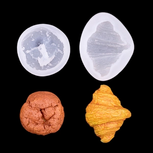 Macro shot of silicone pastry molds with realistic croissant and donut shaped finished cakes