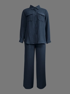 Detail of dark blue textured fabric on casual long-sleeved shirt and trousers set