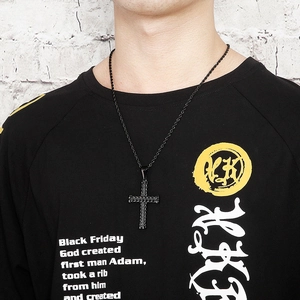 Male model wearing a retro black stainless steel cross pendant with textured woven chain