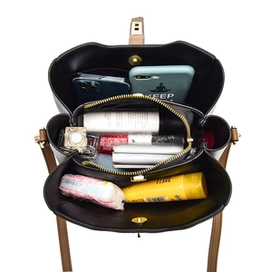 High-capacity black fashion handbag with brown strap showing inner compartments and storage