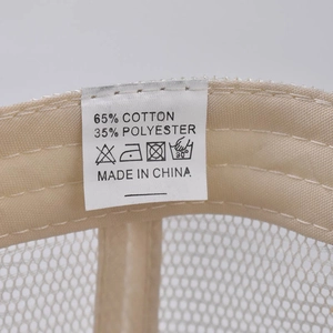 Detail view of the baseball cap care label showing cotton blend fabric and stitching