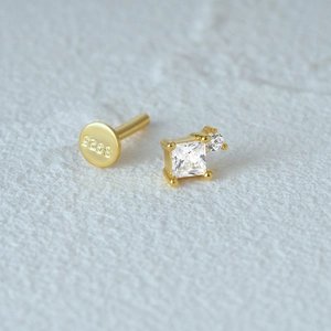 Macro view of gold S925 sterling silver earring post with hallmark and gemstones