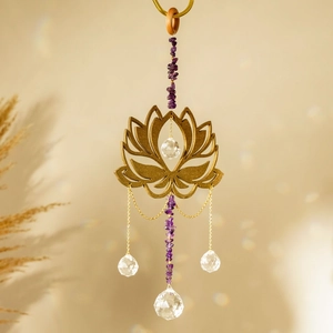Close-up of golden lotus suncatcher with natural amethyst stones and crystal prism pendant
