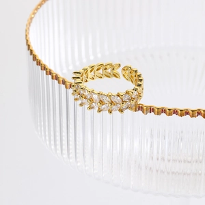 Luxurious adjustable gold leaf ring featuring sparkling inlaid faceted gemstones