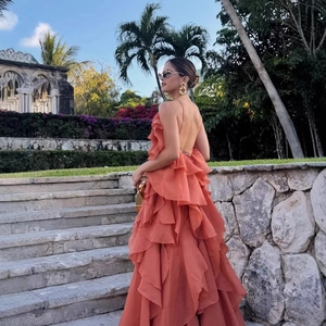 Coral halter neck maxi dress with layered ruffles and open back design for summer
