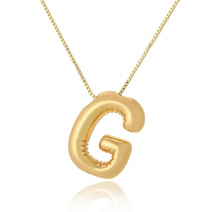 Close-up of golden balloon style letter G pendant with a polished metallic finish
