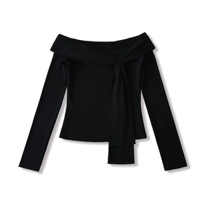 Detail of black off-shoulder long sleeve top featuring elegant knot and drape design