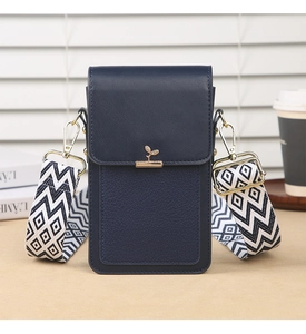 Detail of navy blue textured leather phone bag with golden leaf buckle and woven strap