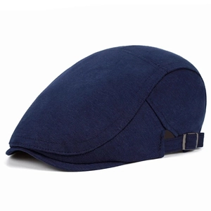 Close-up of classic navy flat cap featuring decorative stitching and a metal adjuster