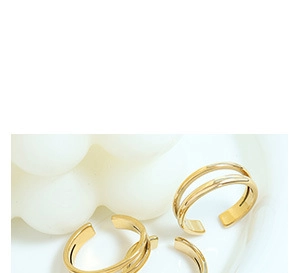 Detailed close-up of gold-plated open rings with a minimalist double-layered design
