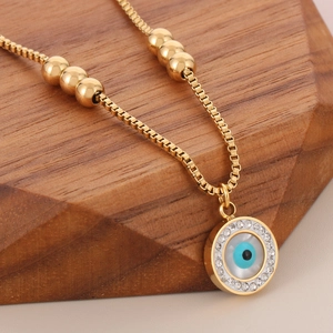 Golden titanium steel anklet featuring evil eye pendant with crystal accents and beads
