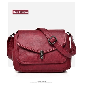 Detail of red litchi texture PU leather shoulder bag with vintage metal buckle clasp
