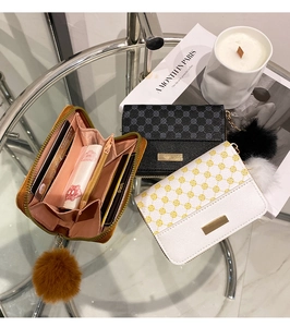 Detail view of women's short floral PU leather wallets with gold metal logo and compartments