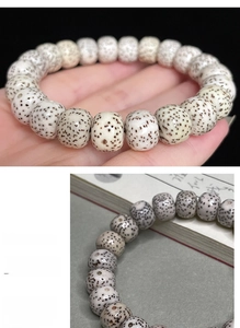 Macro shot of polished moon and star bodhi seed prayer beads with natural texture