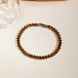 Detailed shot of brown bicone gemstone beads on a bracelet with silver metal clasp