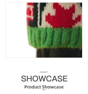 Close-up of Christmas knitted wine bottle cover with red and green maple leaf pattern