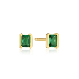 Detail of rectangular emerald green stud earrings with polished gold-plated setting