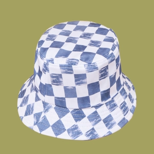 Detail view of blue and white checkered sun hat fabric with vintage washed texture