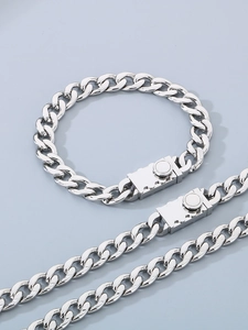 Detail of silver stainless steel NK Cuban chain bracelet with a square push button box clasp