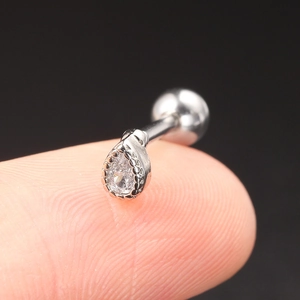 Close-up of teardrop zircon piercing stud in silver finish on a fingertip