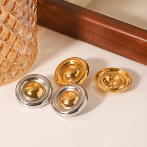 Classic 18K gold stainless steel button earrings set on a white surface with warm light