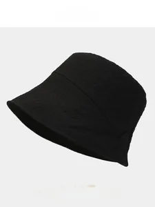 Detailed texture of black textured fabric on a foldable sun bucket hat for women