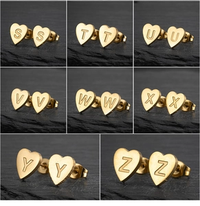 Detailed view of heart-shaped gold stainless steel earrings with matte alphabet engravings