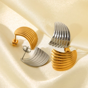 Detailed macro view of fan-shaped striped earrings in polished gold and silver steel finish