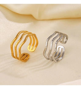 Close-up of three-layer wave rings in gold and silver finish with hammered texture