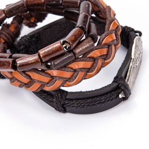 Detail of multi-layer leather bracelets with brown wood beads and metal charms