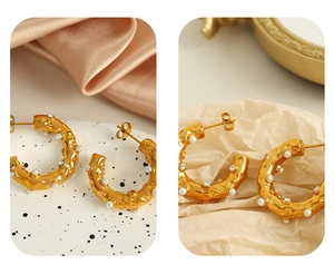 Detail of 18K gold-plated C-shape hoop earrings with embedded pearls and crystals
