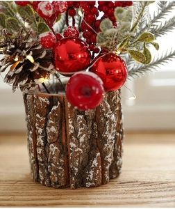 Close-up of Christmas centerpiece with red berries, pine cones and warm LED lights