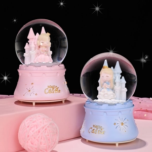 Detailed view of pink and blue magic castle crystal balls with princess figurines