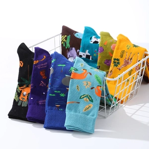 Colorful mid-calf cotton socks with animal patterns in a white metal wire basket