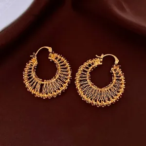 Chic hollow woven gold hoop earrings for women with intricate braided metal texture