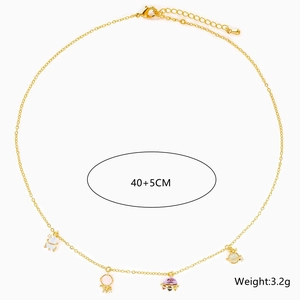 Detailed close-up of 18K gold-plated space necklace with planet and astronaut charms