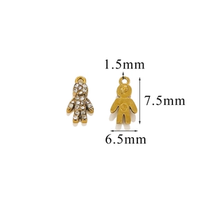 Detailed view of tiny golden doll pendant with white rhinestones and specific size dimensions